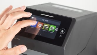 CT4-LX printer’s full-color touchscreen being operated by a finger