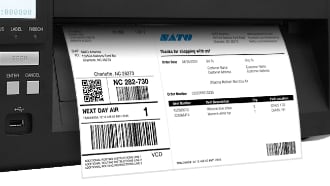 SATO SG112-ex wide-format thermal label printer with shipping label printed